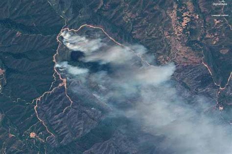 Crews gain on California wildfire as milder temperatures prevail