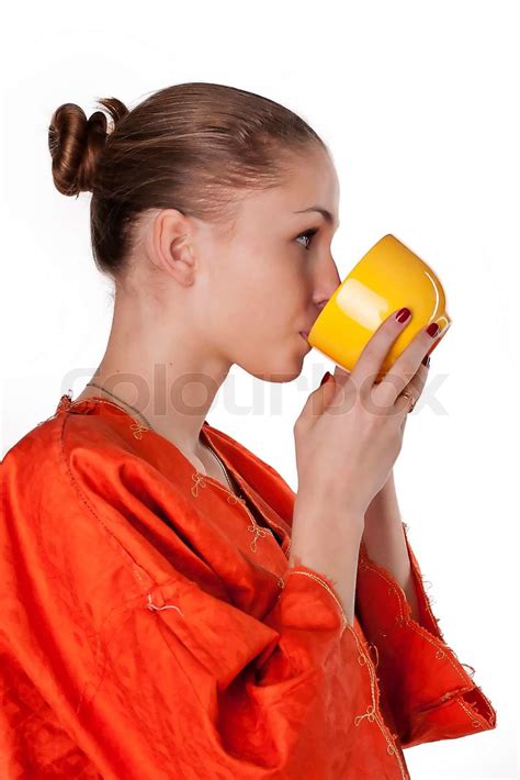 girl in a dress drink from a cup | Stock image | Colourbox