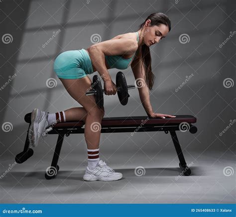 Young Woman Doing Dumbbell Row Exercise on Bench Stock Image - Image of ...
