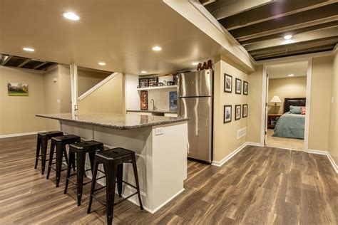 Basement finish with exposed ceilings and beams LVT flooring and ...