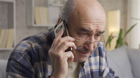 The old man gets bad news and gets upset while talking on the phone ...