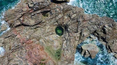 Aerial shots of the turquoise water, reef formations, beach and shipwreck at Henrietta Rocks.