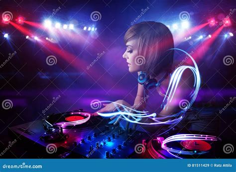 Disc Jockey Girl Playing Music with Light Beam Effects on Stage Stock ...