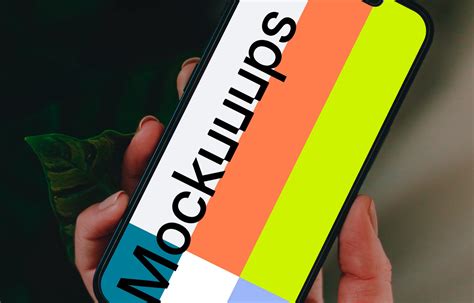 Hand holding iPhone 13 mockup - Mockuuups Studio