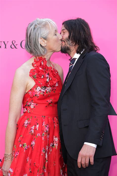 Keanu Reeves kisses Alexandra Grant with eyes open on red carpet