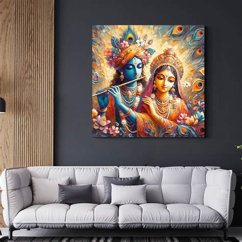 The painting shows Radha in orange and pink, and Krishna in blue with a ...