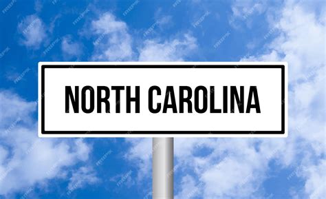 Premium Photo | North carolina road sign on sky background