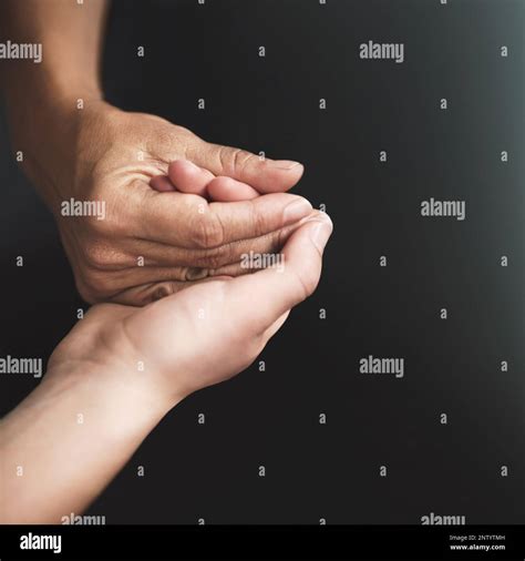 Love is a verb. Cropped shot of two people holding hands in comfort ...