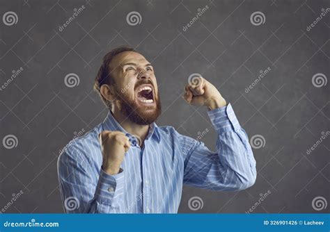 An Angry Frustrated Aggressive Young Man Clenching Fists and Screaming ...