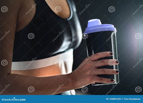 Protein Shake after Workout and Gym Training. Fit Woman Holding Bottle of Sport Drink, Whey or ...
