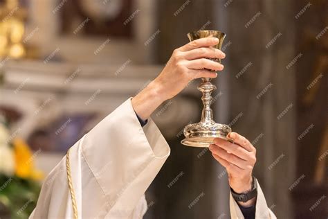 Premium Photo | The elevation of the Goblet with the sacramental wine ...