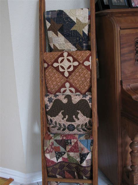 Quilts on ladder in foyer