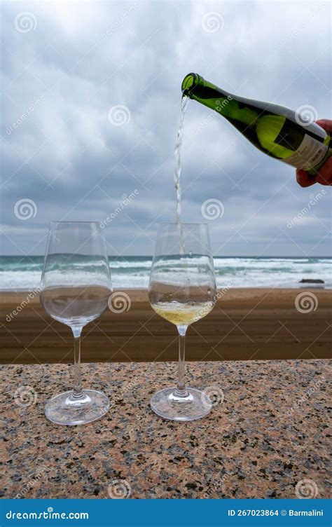 Pouring of Txakoli Sparkling Very Dry White Wine Produced in Spanish Basque Country Served ...