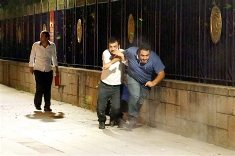 Supporters of Turkish President Recep Tayyip Erdogan wave flags as they ...