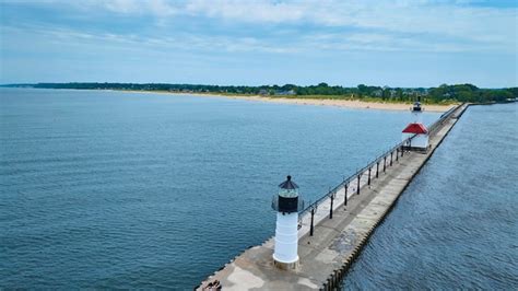 Aerial view of twin lighthouses on north pier in serene coastal setting ...