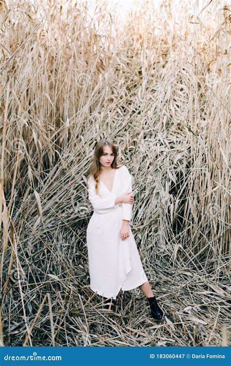 Portrait of a Young Attractive Girl in a Light White Dress and Black ...