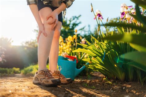 Person holding leg from aches and pain | Boiron USA