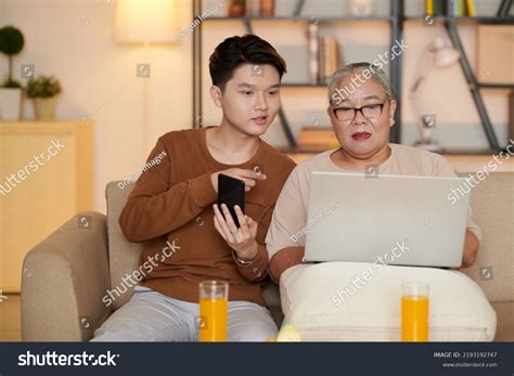 Vietnamese Teenage Boy Explaining Grandmother How Stock Photo ...