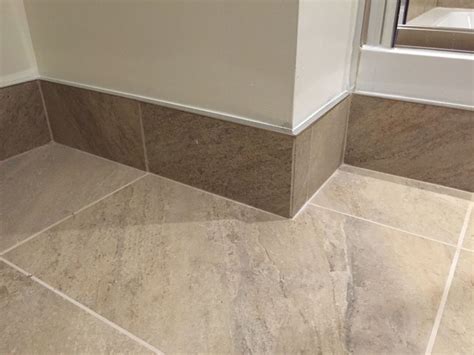 Tiled skirting board with chrome trim | Tile baseboard, Bathroom floor ...