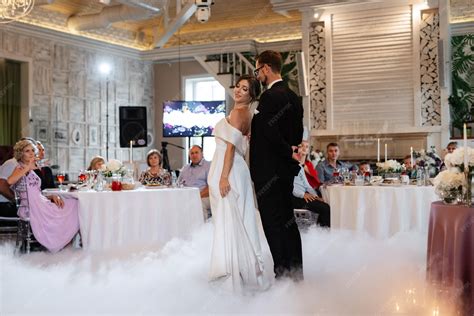 Premium Photo | The first dance of the bride and groom inside a restaurant