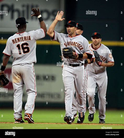 San Francisco Giants shortstop Edgar Renteria gives left fielder John ...