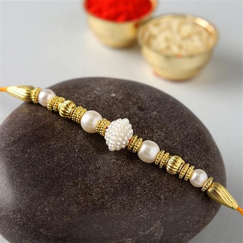 Send Two Elegant Pearl Rakhis And Motichoor Laddoo Online