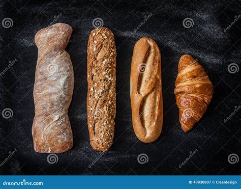 Different Kinds of Bread Rolls on Black from Above Stock Image - Image ...