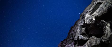Download wallpaper 2560x1080 rocks, stones, starry sky, stars, night ...