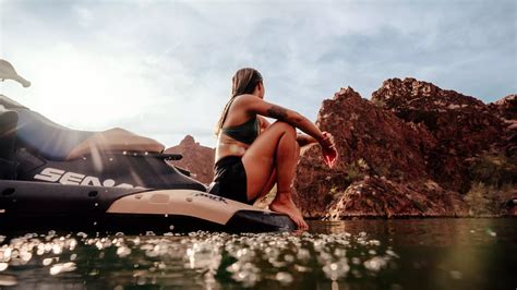 A woman performing a stunt on her Sea-Doo Spark with the words “Make Waves sales event”