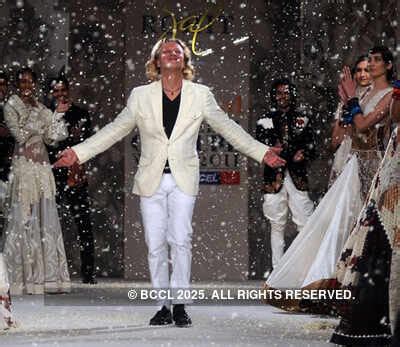 Designer Rohit Bal walks the ramp after his creations were showcased on ...