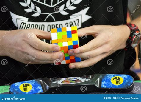 Close-up of Hands Solving a Rubik`s Cube. Color Puzzle Editorial ...