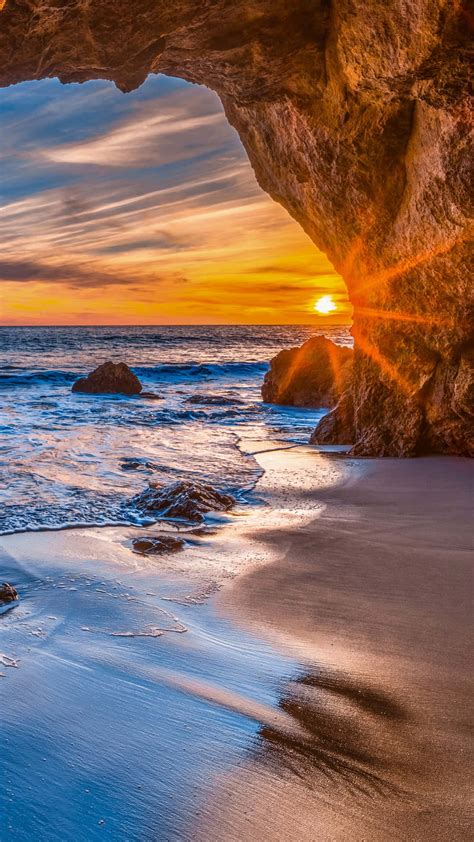 Download Iphone X Malibu Background Sunset In Cave | Wallpapers.com