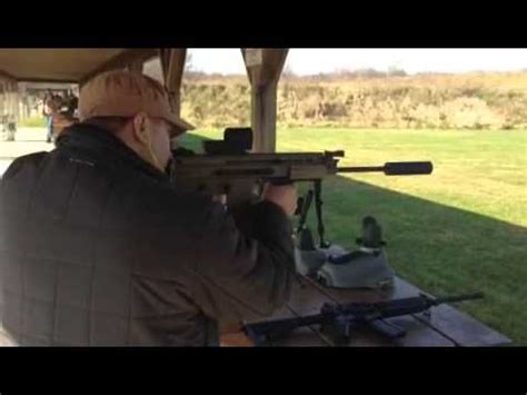 Four figures in action, including a man with a top knot crouching and shooting, a figure in a green