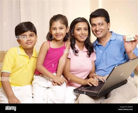 Indian parents children home laptop hi-res stock photography and images ...