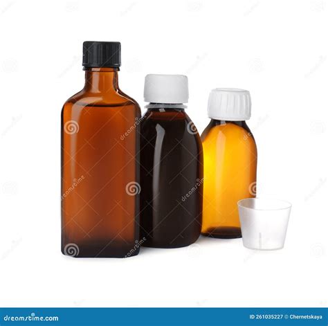Bottles of Syrups with Measuring Cup on White Background. Cough and ...