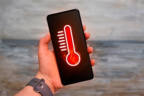 https://static1.howtogeekimages.com/wordpress/wp-content/uploads/2024/04/a-hand-holding-a-smartphone-with-a-thermometer-indicating-that-the-device-is-overheating.jpg