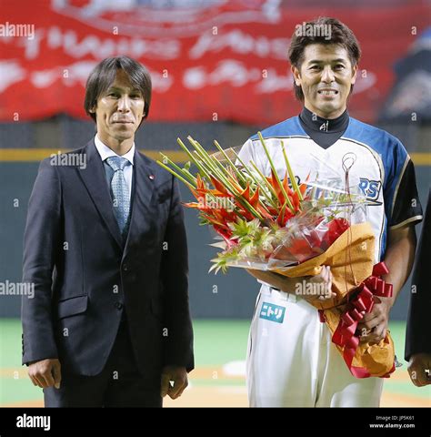 SAPPORO, Japan - Retiring Atsunori Inaba (R) of the Nippon Ham Fighters ...