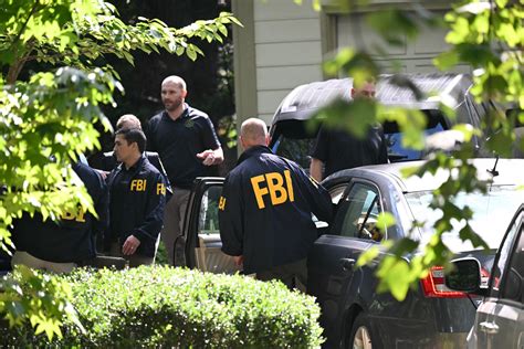 FBI Agents Exit John Bolton's Office With Boxes in Raid - Newsweek