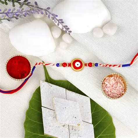 Send Evil Eye Rakhi with Kaju Katli - For Hungary Online | Rakhibazaar.com