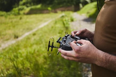 Man flying a high speed racing drone with remote controller remote ...