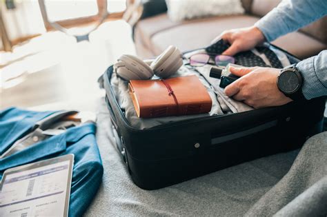 https://www.amexglobalbusinesstravel.com/wp-content/uploads/2024/12/traveler-packing-suitcase.jpg?utm_source=chatgpt.com