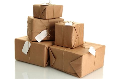 Parcels boxes with kraft paper isolated on white | Premium Photo
