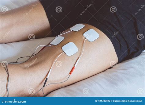 Patient Applying Electrical Stimulation Therapy on Leg. Electric Stock ...