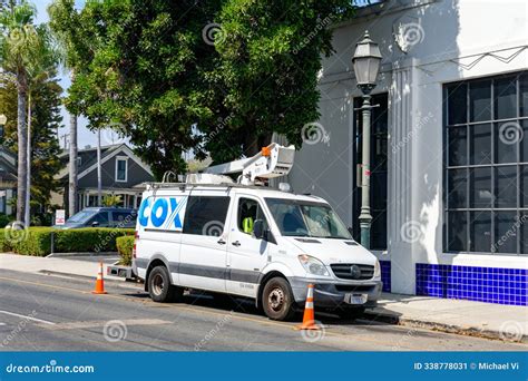 Cox Communications Service Van is Parked on a Street. Safety Cones are ...