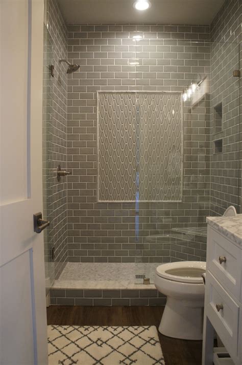 Gray subway tile shower with framed accent panel