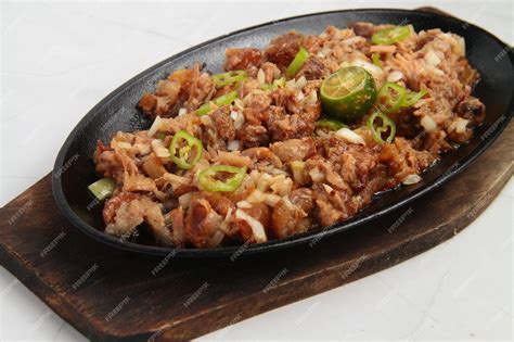 Premium Photo | Photo of freshly cooked filipino food called pork sisig