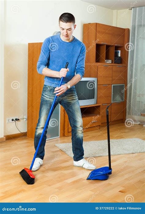 Man Sweeping The Floor At Home Stock Photography - Image: 37729222