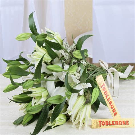 Toblerone Chocolate with White Lilies Bouquet – Flowersacrossindia.com
