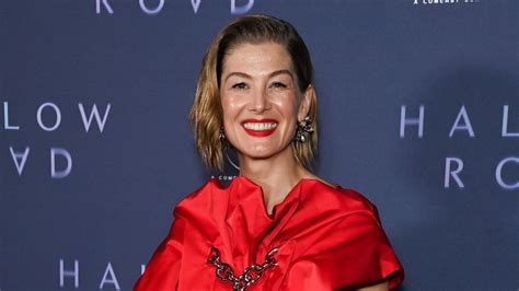 Rosamund Pike dazzles in red satin dress by Simone Rocha at 'Hallow ...