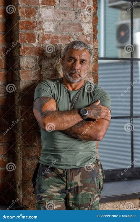 A Soldier in Camouflage, a Soldier Stands Against the Wall.a Mature ...